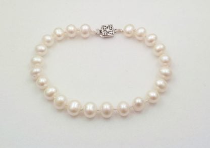 Graceful, hand knotted white, freshwater potato pearl bracelet with sterling silver clasp